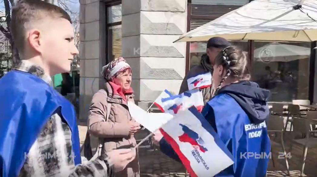 В Симферополе раздавали флажки и ленточки в честь годовщины воссоединения Крыма с Россией